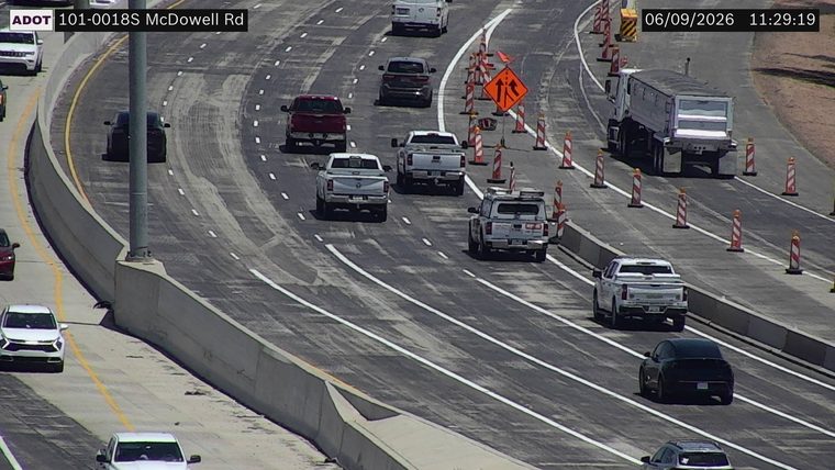 Construction cones and orange traffic signs in the right lanes