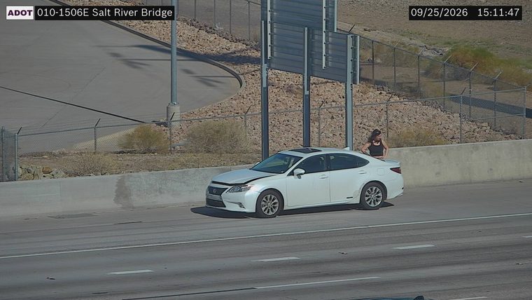 White sedan with hood up on the right shoulder