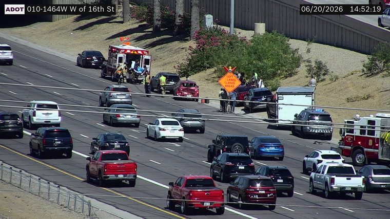 Ambulance and multiple vehicles involved in a crash in the left lanes with a 'Left Lanes Closed Ahead' sign