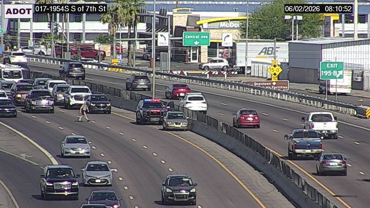 Person crossing the roadway in the left lanes