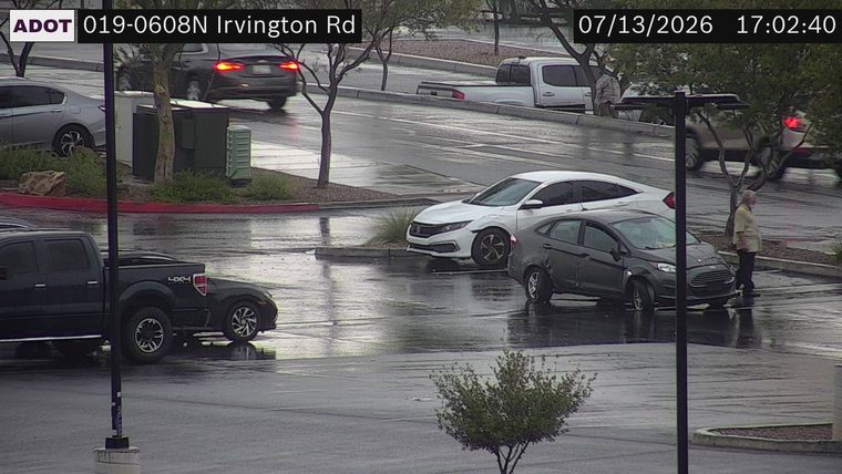 Gray sedan with visible front-end damage and flat tires