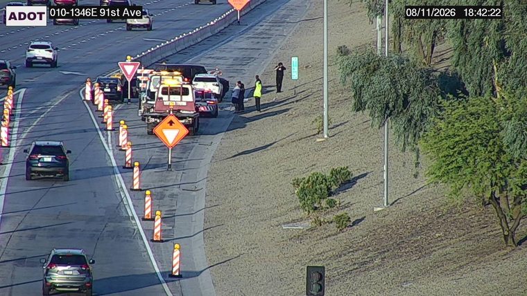 Tow truck and several people on the right shoulder