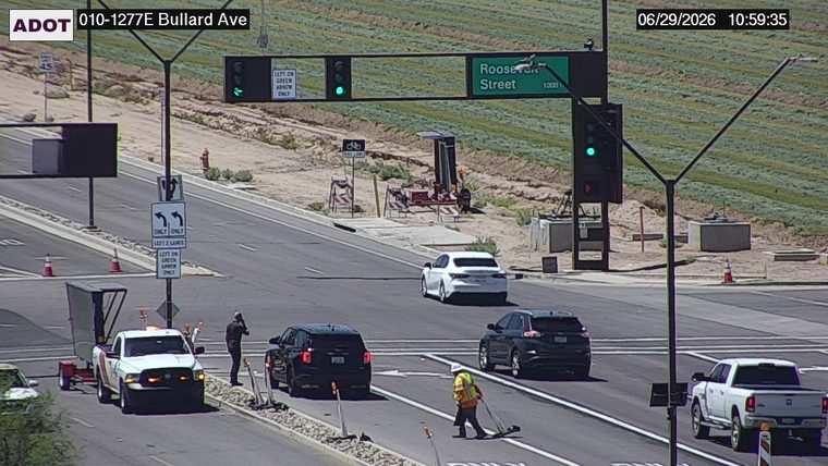 Worker in high-visibility vest and hard hat on the roadway