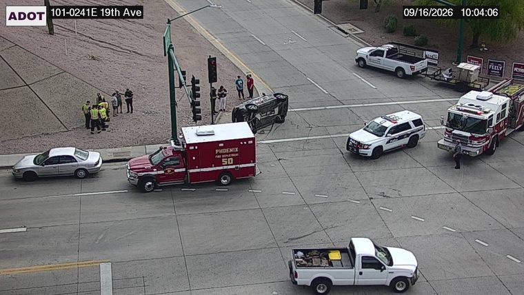 Overturned vehicle in the intersection with emergency responders present