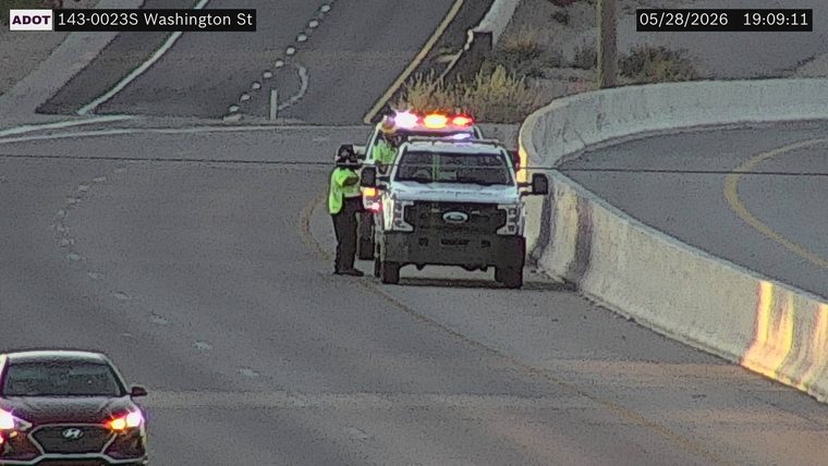 Tow truck with hazard lights on the right shoulder