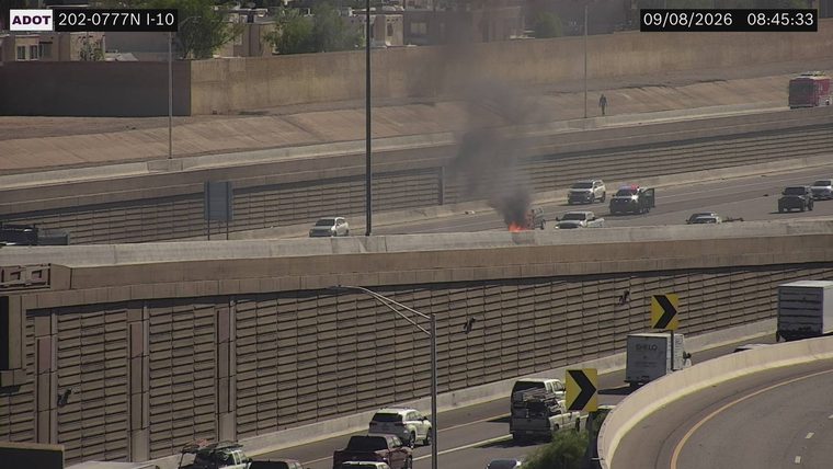 Vehicle fire with smoke in the left lanes