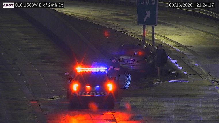 Police car with red and blue lights on the shoulder