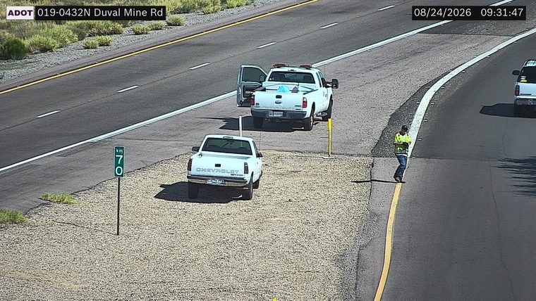 Worker in high-visibility vest on the right shoulder