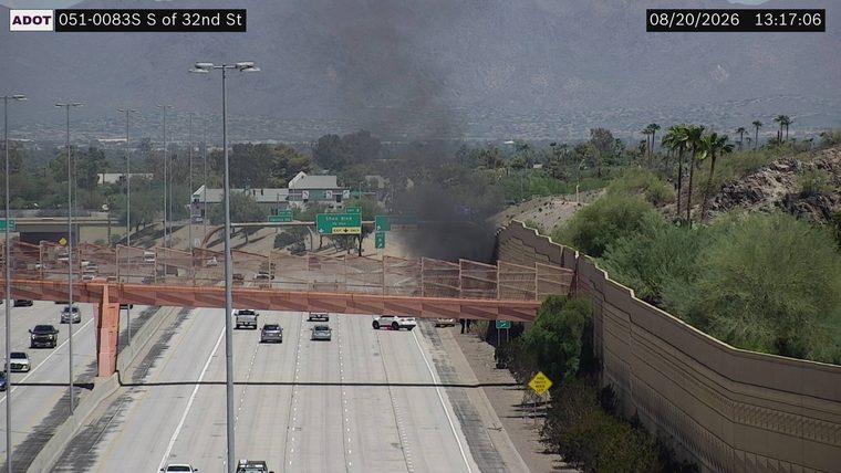 Black smoke billowing from the right side of the roadway near the Shea Blvd exit