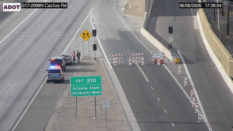 Road closed with barriers and cones in the right lane
