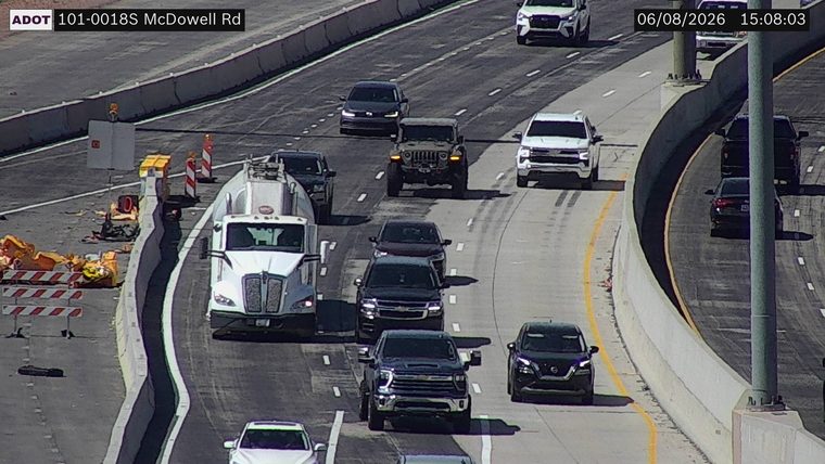 Construction cones and barriers on the left shoulder