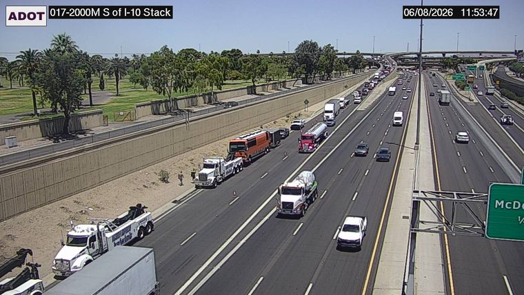 Tow truck and orange bus on the right shoulder