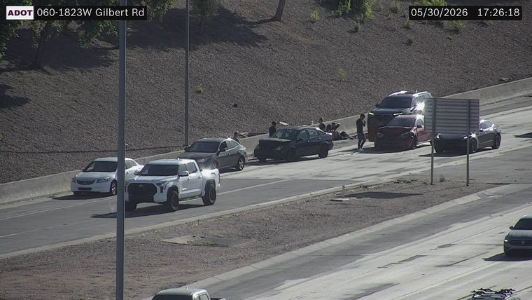 Tow truck and several people around multiple vehicles in the right lane