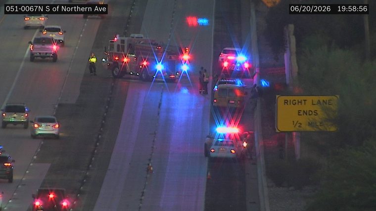 Fire truck and multiple police cars with red and blue lights on the roadway