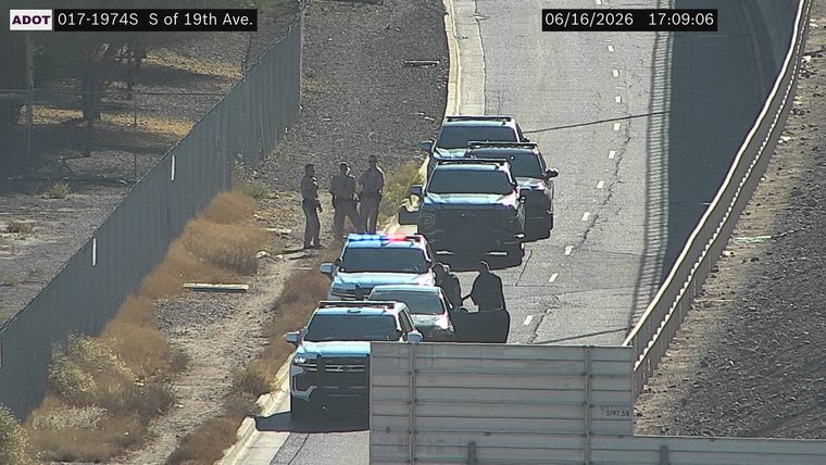Police car with red and blue lights on the shoulder