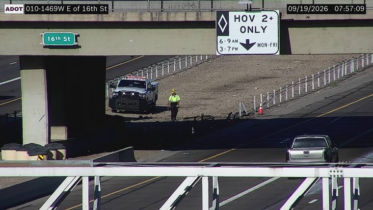 Worker and service truck on the shoulder