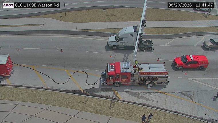 Buckeye Fire Dept. engine and a red SUV with emergency lights on the roadway