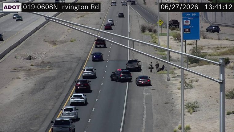 Police car with red and blue lights on the right shoulder