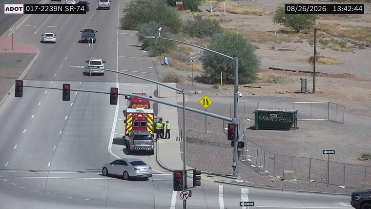 Ambulance and two individuals on the sidewalk