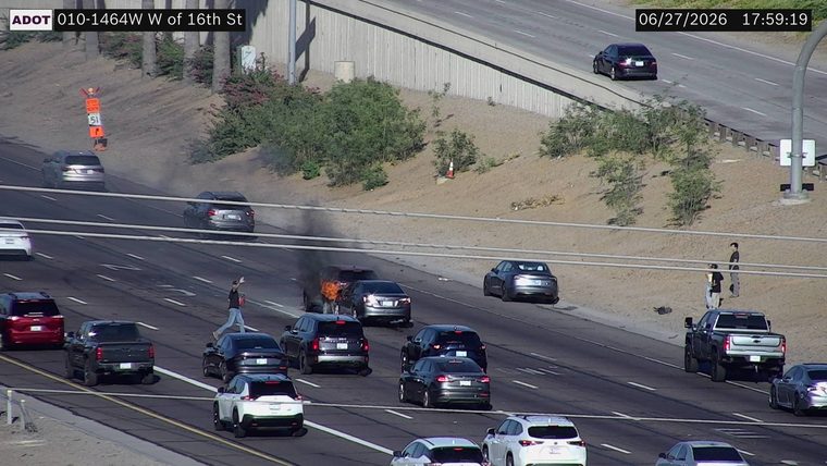 Vehicle on fire in the middle lane
