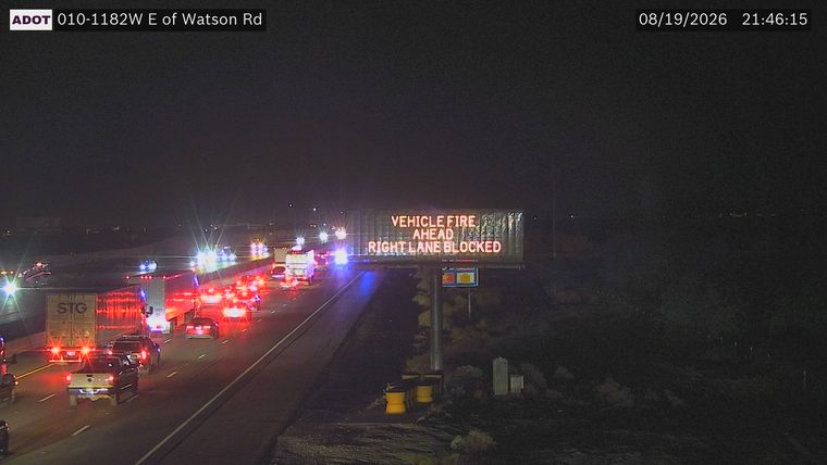 Multiple emergency vehicles with red and blue lights on the roadway