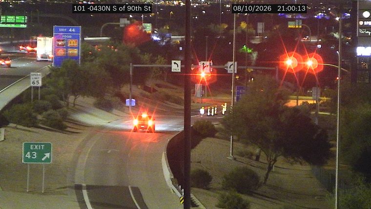 Vehicle with flashing red lights on the roadway
