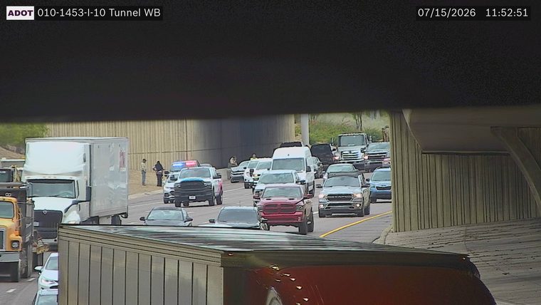 Police car with red and blue lights on the shoulder