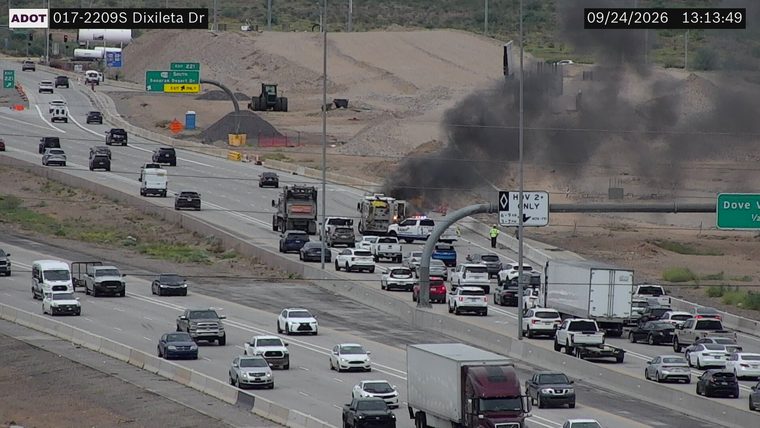 Black smoke and flames from a vehicle in the right lanes