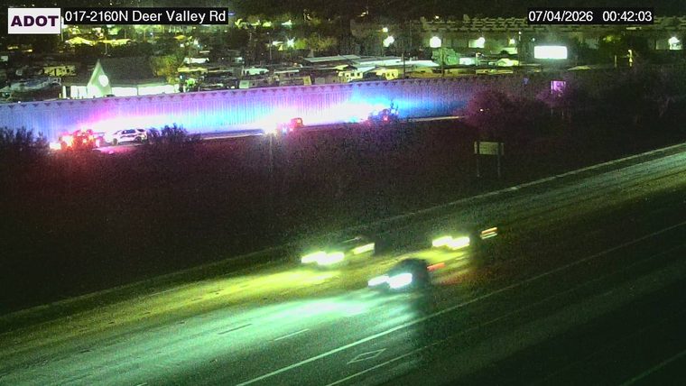 Police car with blue and red lights on the shoulder