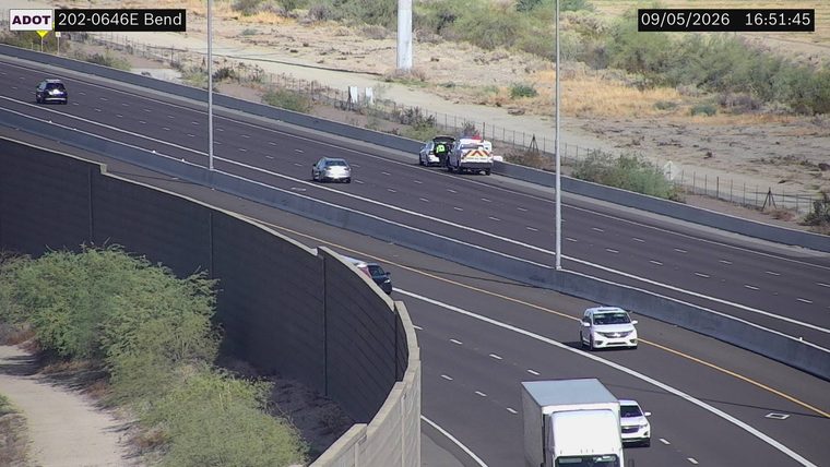 Ambulance and a person in hi-vis vest on the right shoulder