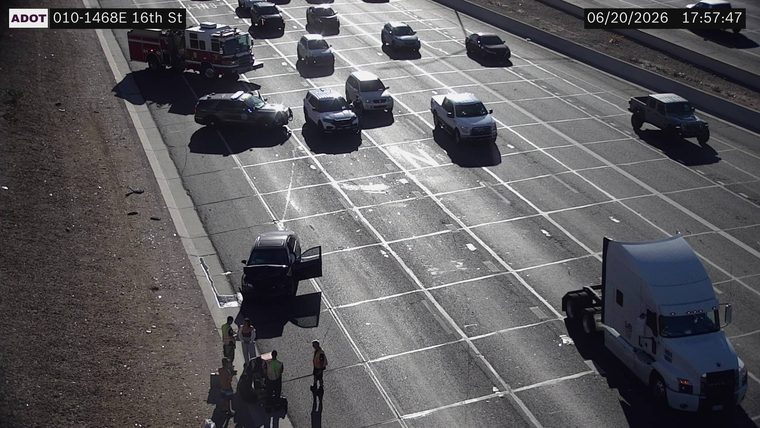Fire truck and police car with people on the right shoulder