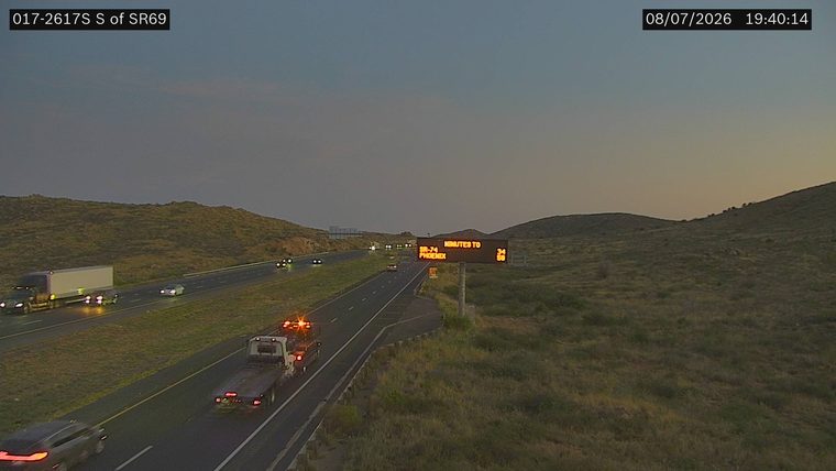 Tow truck with hazard lights on in the right lane
