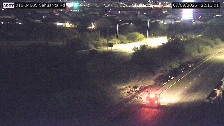 Vehicle with red and blue flashing lights on the right shoulder