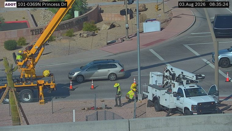 Construction workers and equipment in the right lane