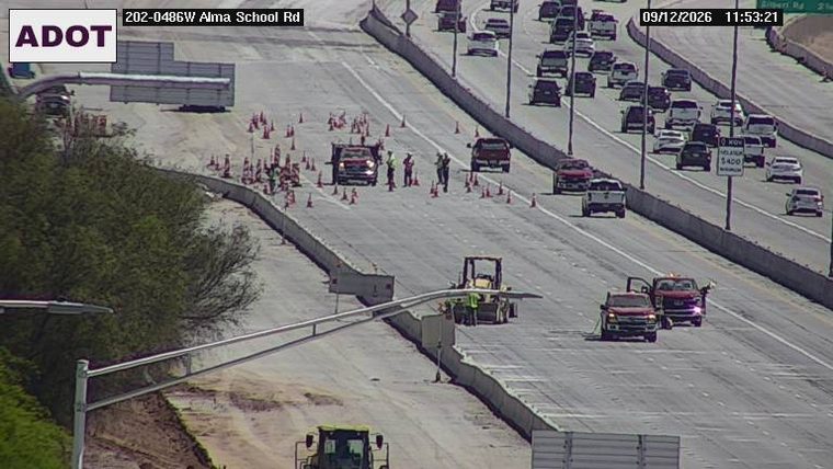 Construction cones and workers in the left lanes