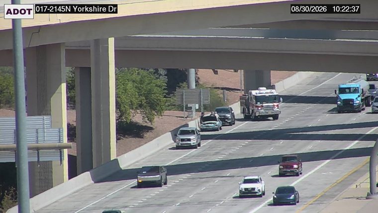 Fire truck with red and blue lights on the right shoulder