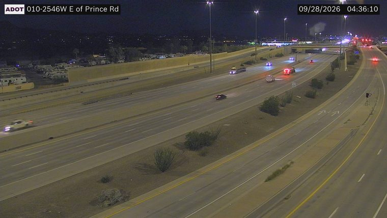 Multiple emergency vehicles with red and blue lights on the roadway