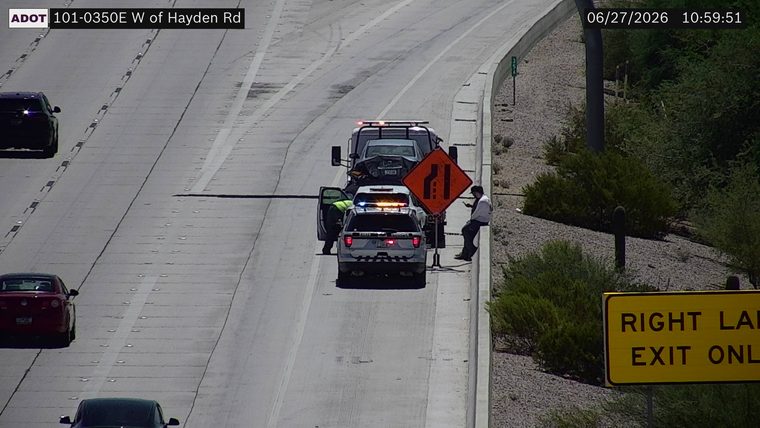 State trooper vehicle with lights on and a tow truck on the right shoulder