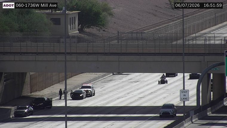 Police car and two individuals in the left lane