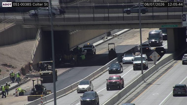 Construction workers and equipment on the roadway