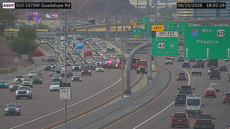 Police car and fire truck with red and blue lights on in the left lanes
