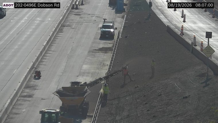 Workers and equipment on the side of the roadway