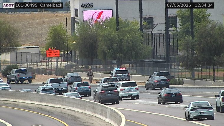 Police car with red and blue lights on the shoulder