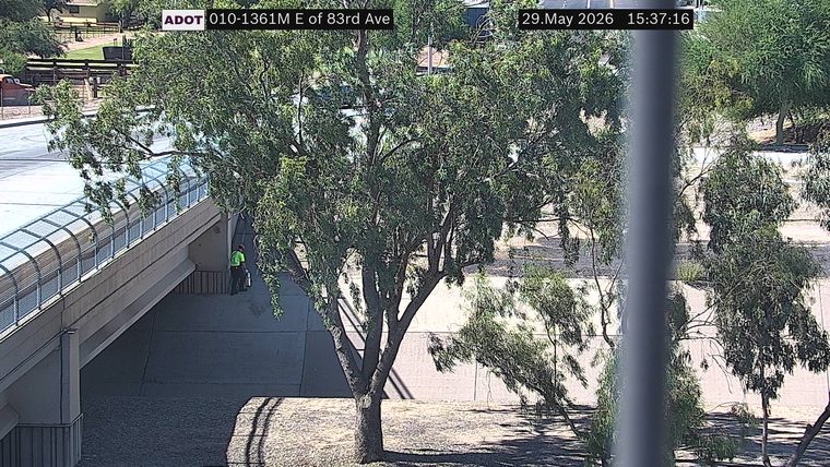 Person with fire extinguisher under bridge