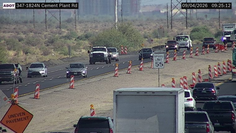 Construction cones and uneven pavement sign in the right lane