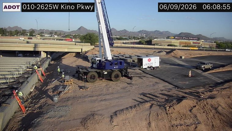 Construction workers and equipment on roadway