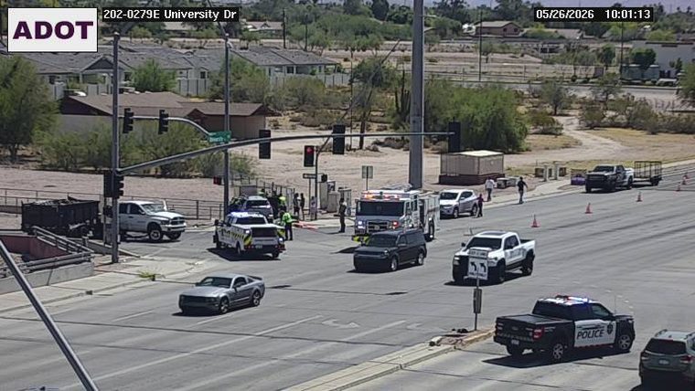 Emergency responders including a fire engine and a police vehicle with lights active at the intersection