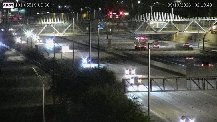 Fire truck with red and blue lights on the right side of the roadway