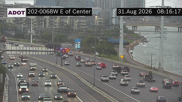 Fire engine and police car with lights on the shoulder