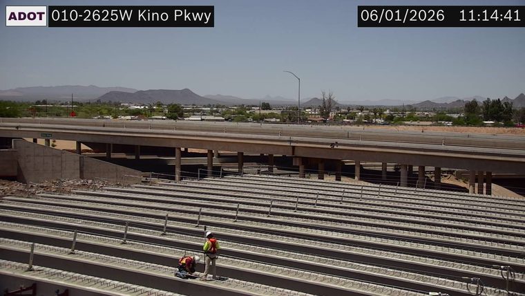 Two construction workers on a bridge under construction